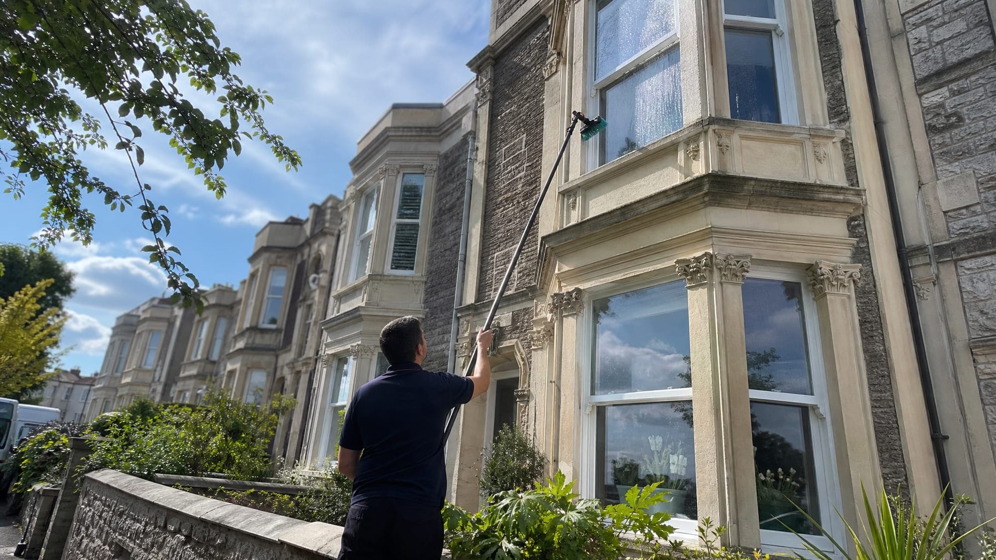 Daz Shine window cleaner using a pure-water pole to clean the windows of a Bristol home